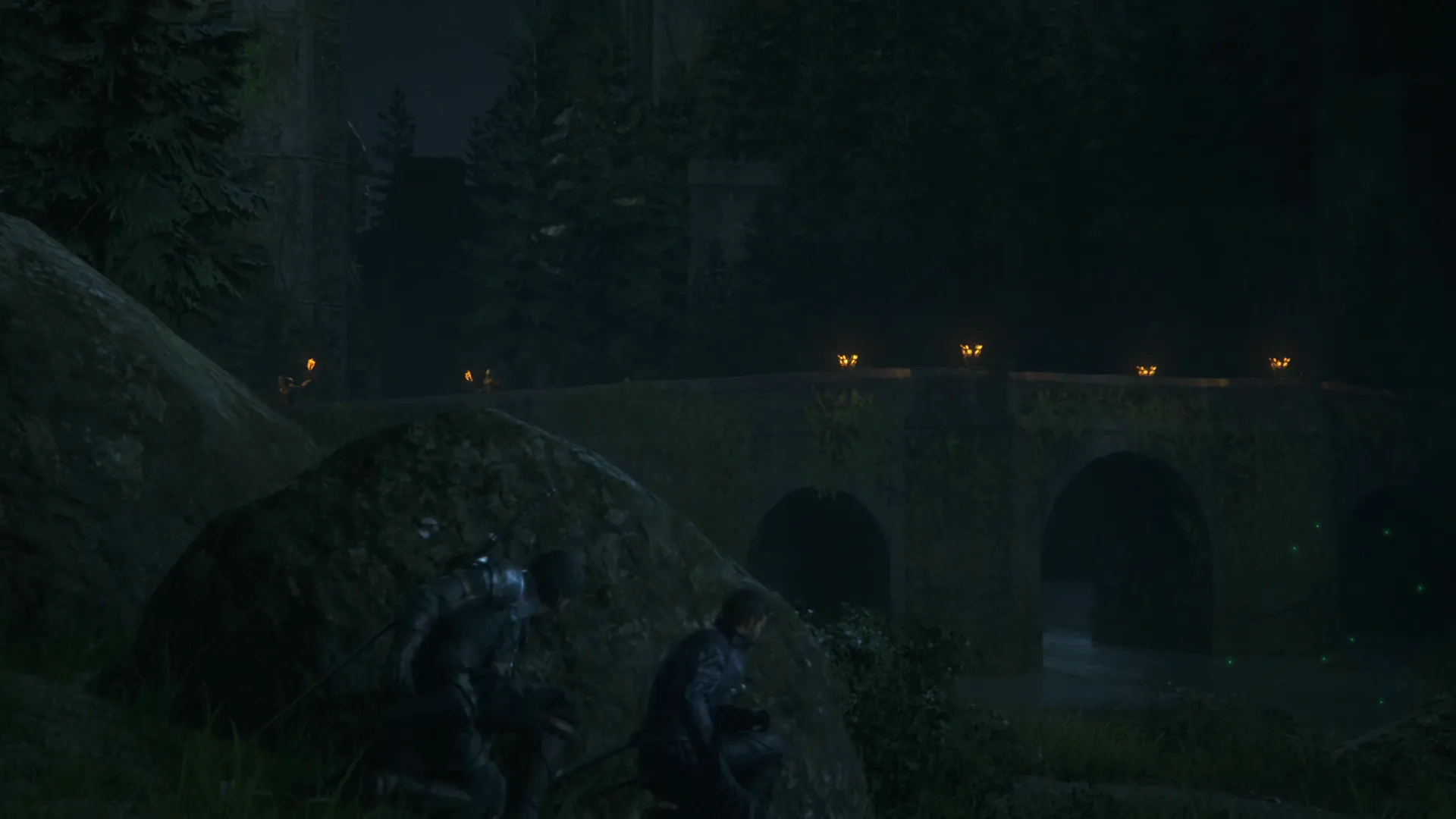 Clive and Cid hiding behind a rock near the bridge leading to Caer Norvent