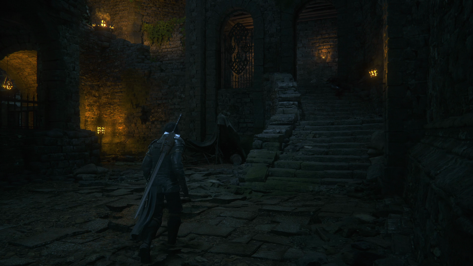 The split pathway that leads down and to the left but also up the stairs on the right
