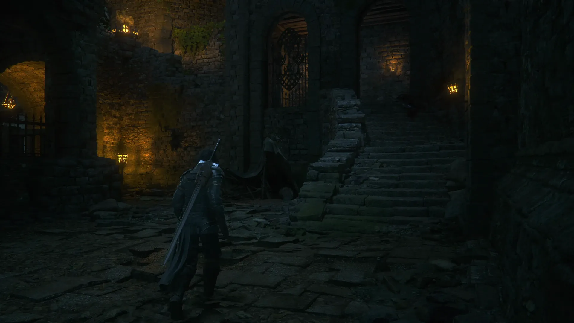 The split pathway that leads down and to the left but also up the stairs on the right